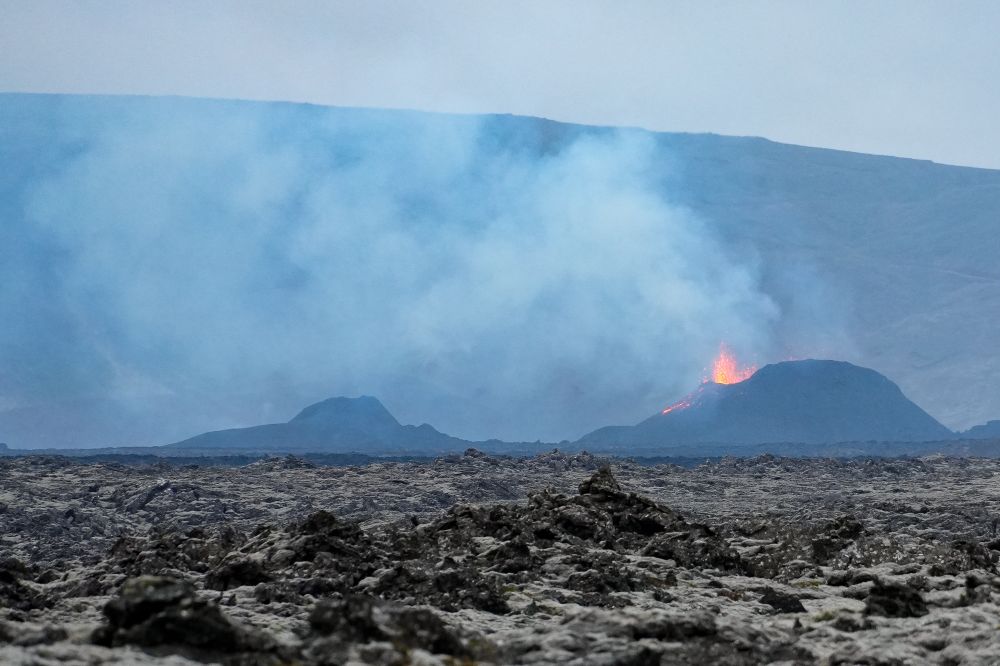 Volcanic eruption viewable from the road. Channels of lava cooling to the left of the active crater. 