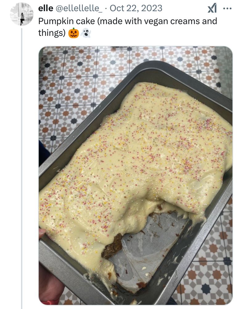 Pumpkin cake made with vegan cream etc - seasonal emojis - sploosh of a cake with very wet icing and emojis. Partially very wet because it’s vegan with lovely patterned tiles in the background 