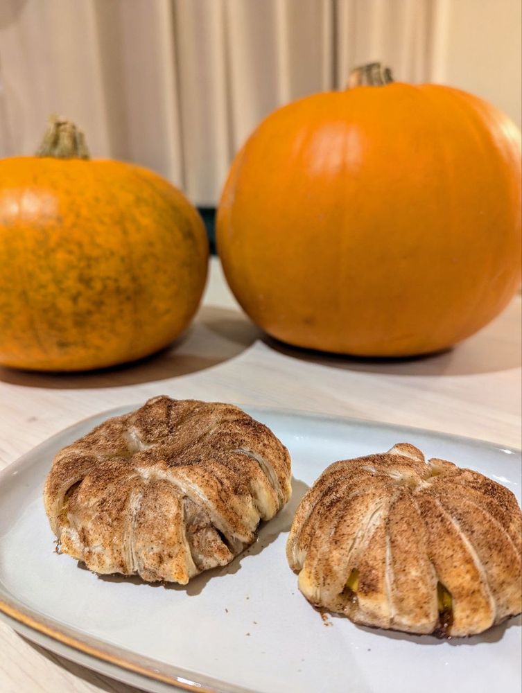 Apple slices with puff pastry and cinnamonned for the season. Two pumpkins in the background because this was pre Halloween carving 