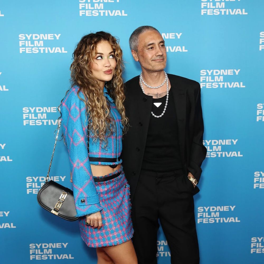 Taika Waititi in Prada and pearls at Sydney Film Festival 2023 with partner Rita Ora.