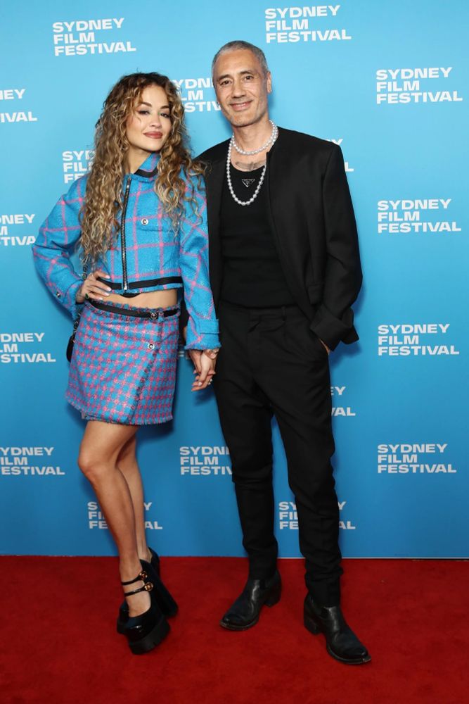 Taika Waititi in Prada and pearls at Sydney Film Festival 2023 with partner Rita Ora.