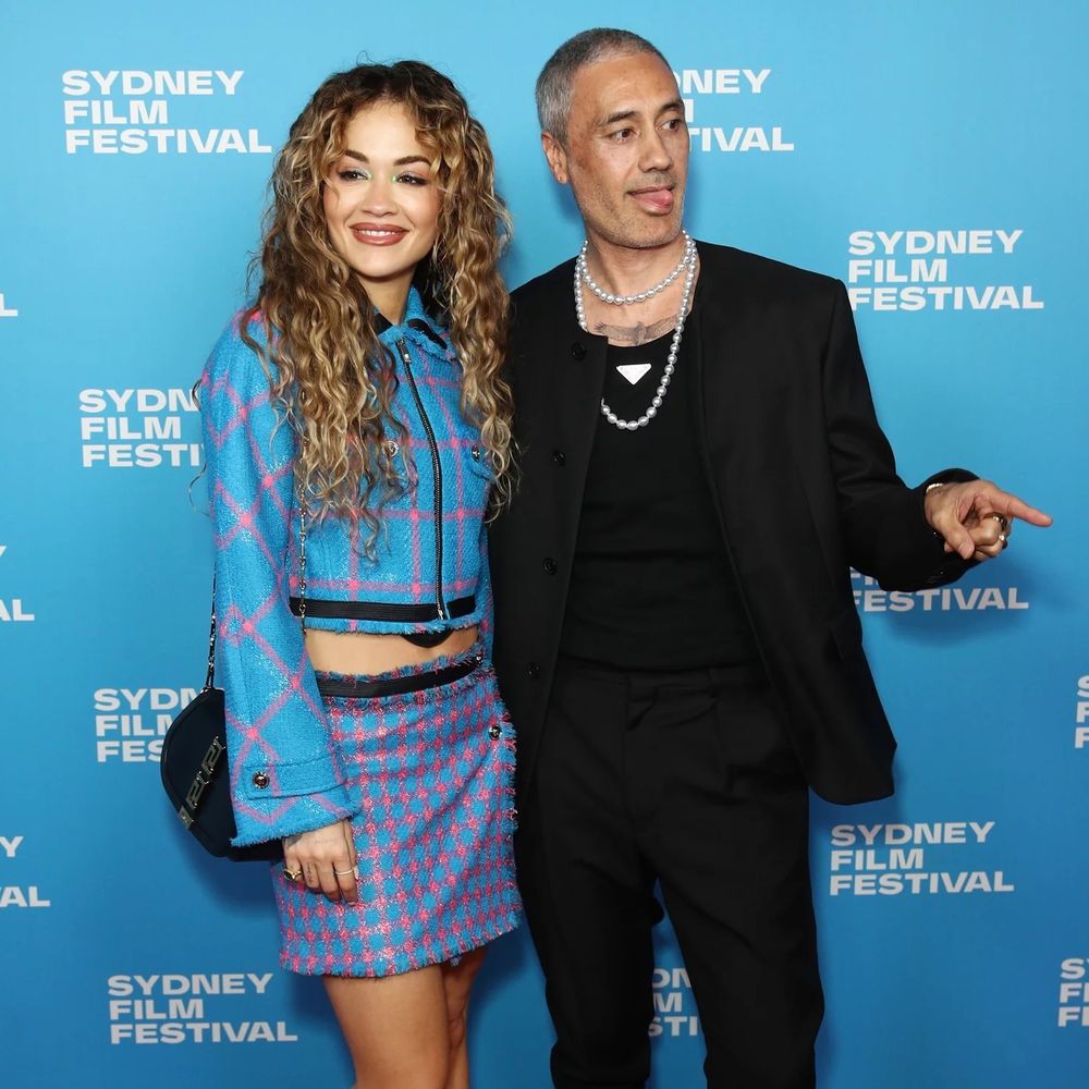 Taika Waititi in Prada and pearls at Sydney Film Festival 2023 with partner Rita Ora.
