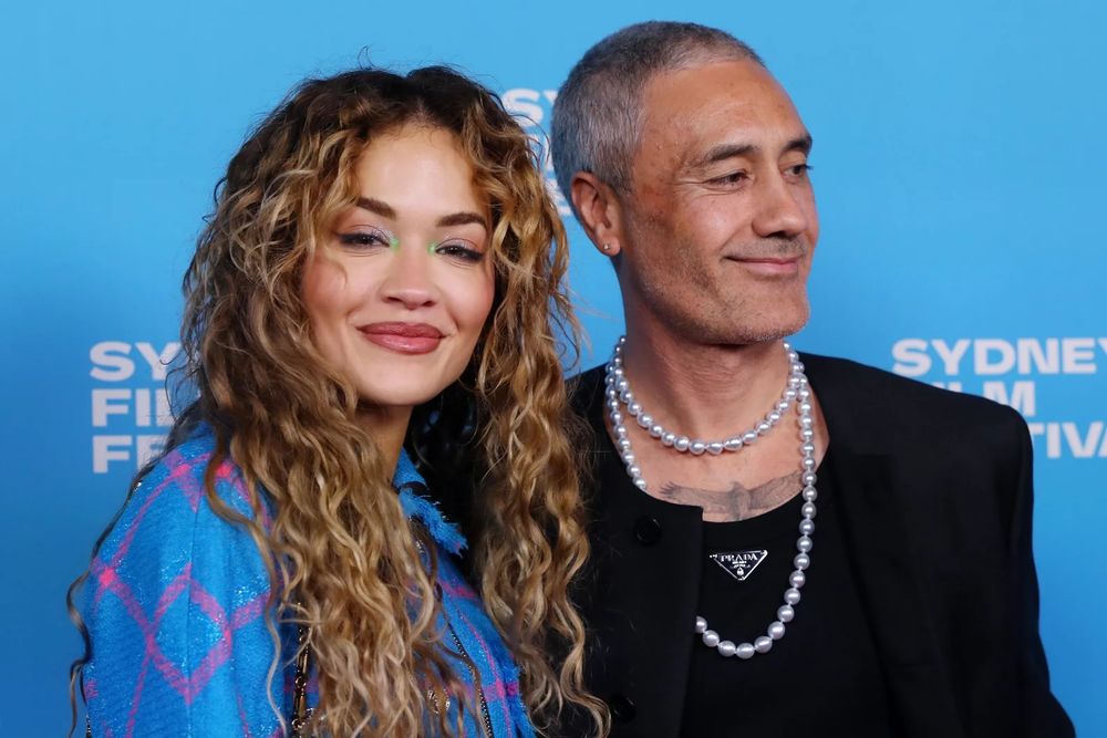Taika Waititi in Prada and pearls at Sydney Film Festival 2023 with partner Rita Ora.