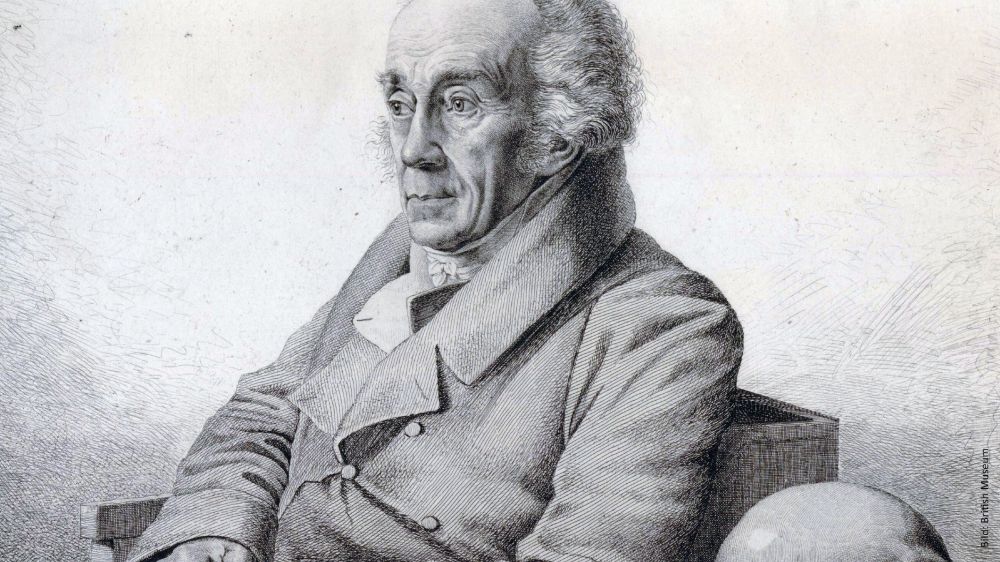 Historische Porträtzeichnung von Johann Friedrich Blumenbach, der in einem Stuhl sitzt. Er trägt einen Mantel mit breitem Kragen und blickt nach rechts. Bild: © The Trustees of the British Museum.