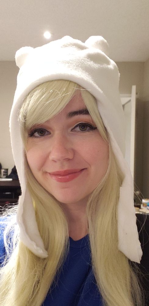 A close up of the felt white, bear like hat I made for my Finn cosplay. Blonde wig, blue t shirt.