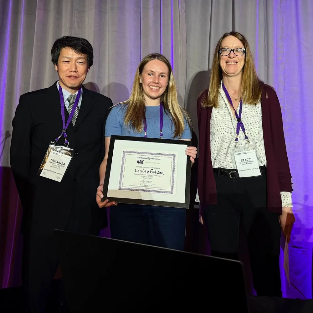Lesley Golden is pictured receiving her award. To her right is Stacie Weninger. To her left is Takahisa Kanekiyo.