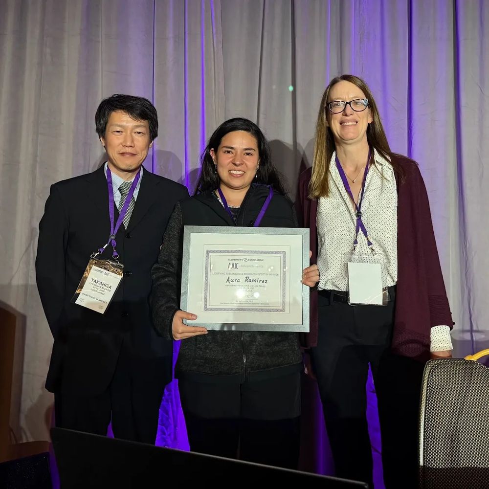 Aura Ramirez is pictured receiving her award. To her right is Stacie Weninger. To her left is Takahisa Kanekiyo.