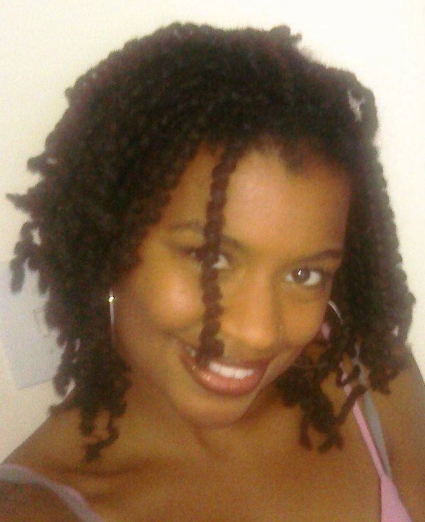 selfie of a black woman, smiling, with tightly curled locs 