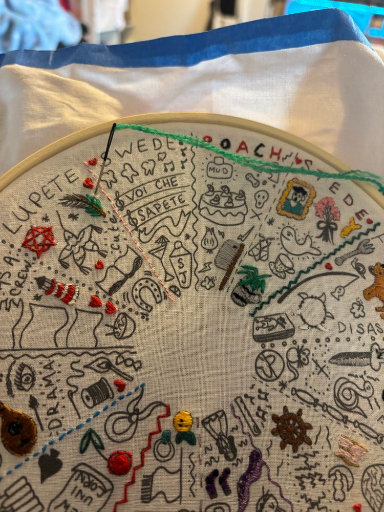 OFMD embroidery with a finished portrait, plant, cleaver, pentagram, flowers, lighthouse and lots of little hearts 