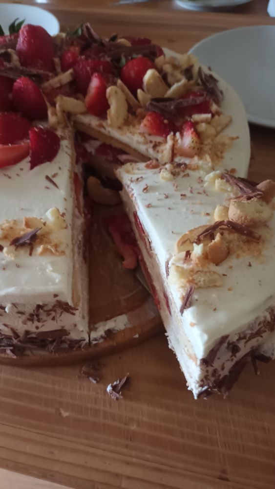strawberry, cream and chocolate cake - a piece is cut out