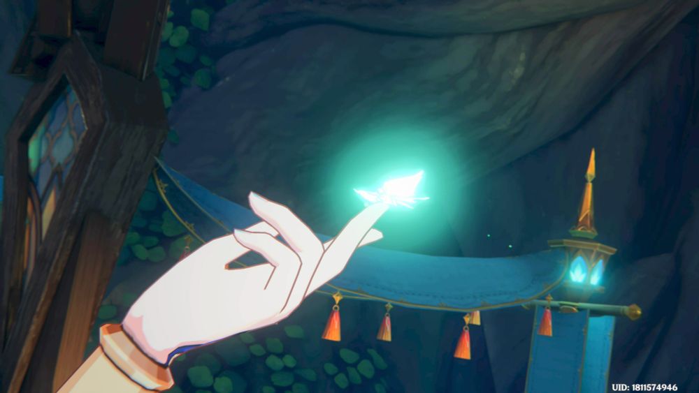 A women's finger held out and perched on the tip is a glowing butterfly 🦋