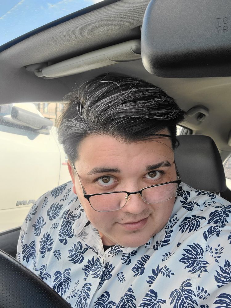 A selfie of a man with graying hair and glasses