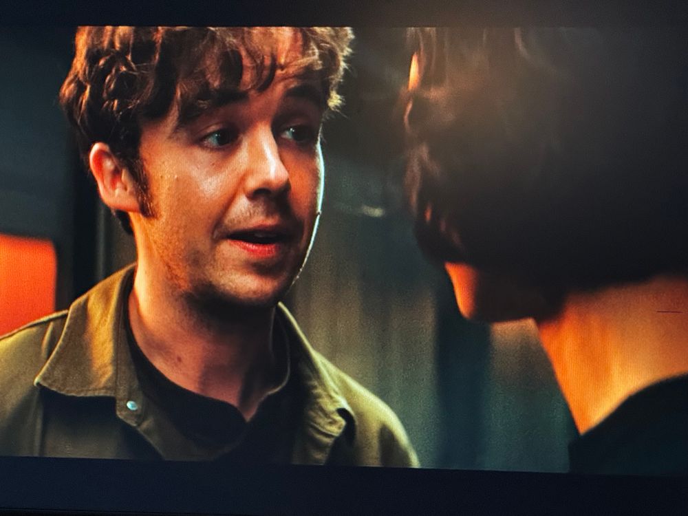 White man talks with white woman, their faces close