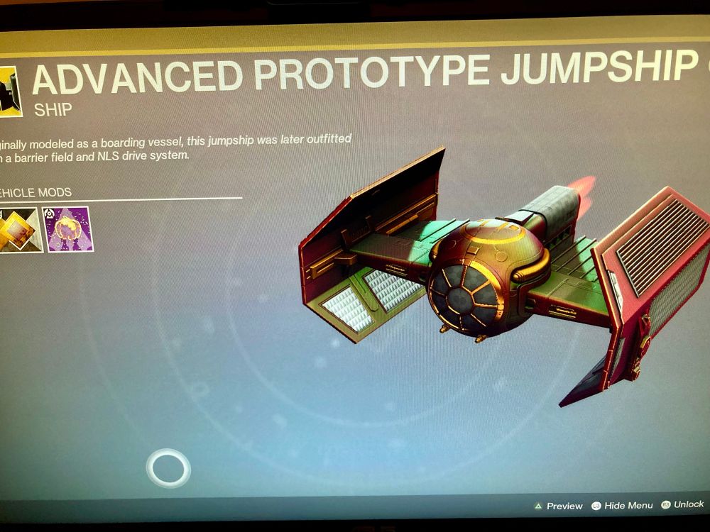 A photo of the Destiny 2 ship screen for the Advanced Prototype Jumpship aka the TIE fighter from Star Wars. The color pallet is bronzes, reds, and greens, with copper highlights. There’s a smashing pumpkin transmat effect assigned to it.