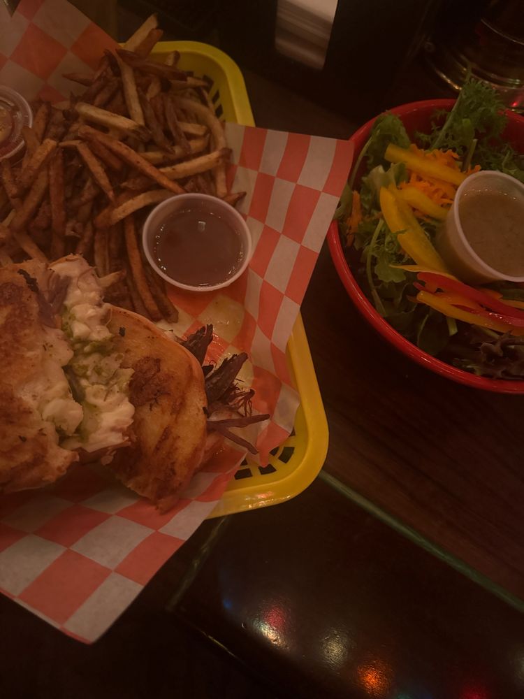 a pic of an Italian beef grilled cheese with au jus and French fries all in one basket, and then a side salad in a bowl. Everything is fresh and thoughtful and bonkers good 