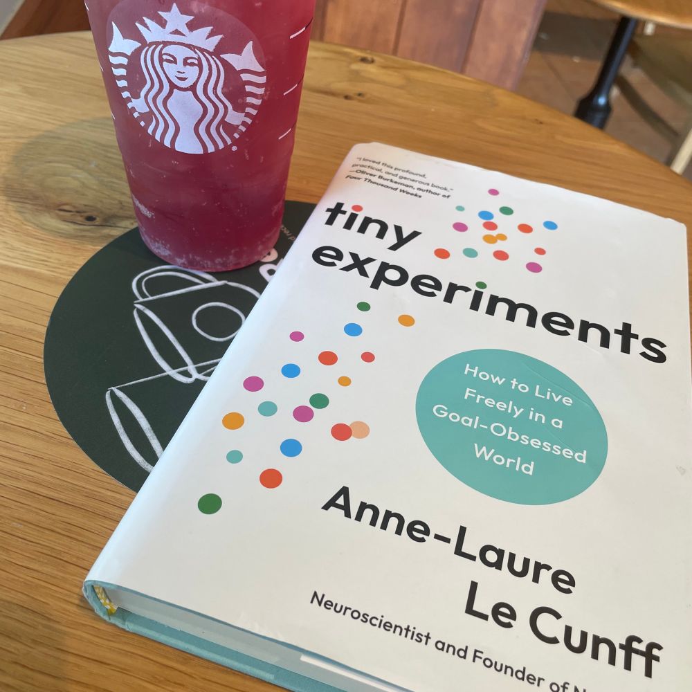 A drink next to a book.