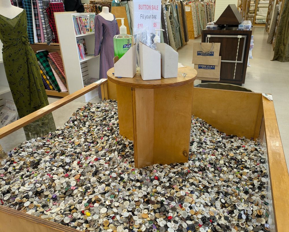 A sea of buttons in a 4-foot bin with a sign that says "fill your bag" and five-dollar and ten-dollar bags.