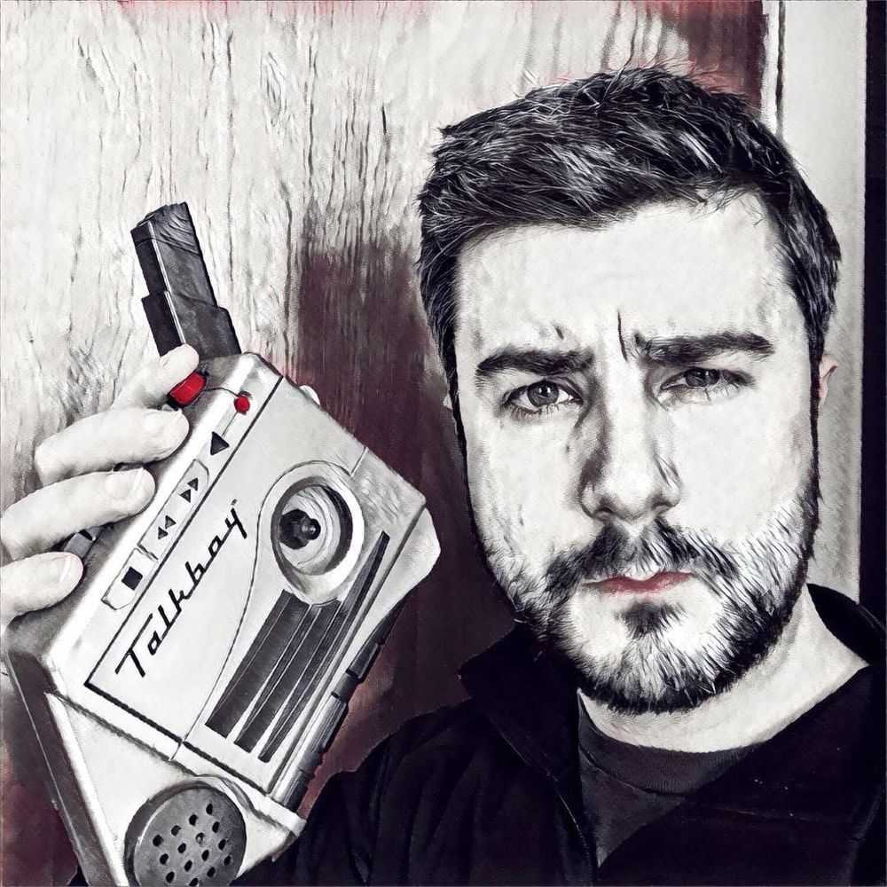 Stylized black and white photo with red highlights of myself holding the Talkboy tape recorder. 