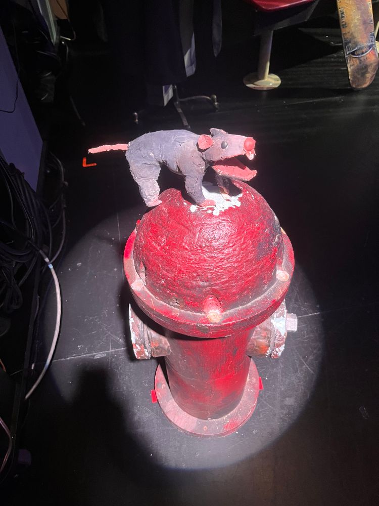 A rat puppet on a hydrant