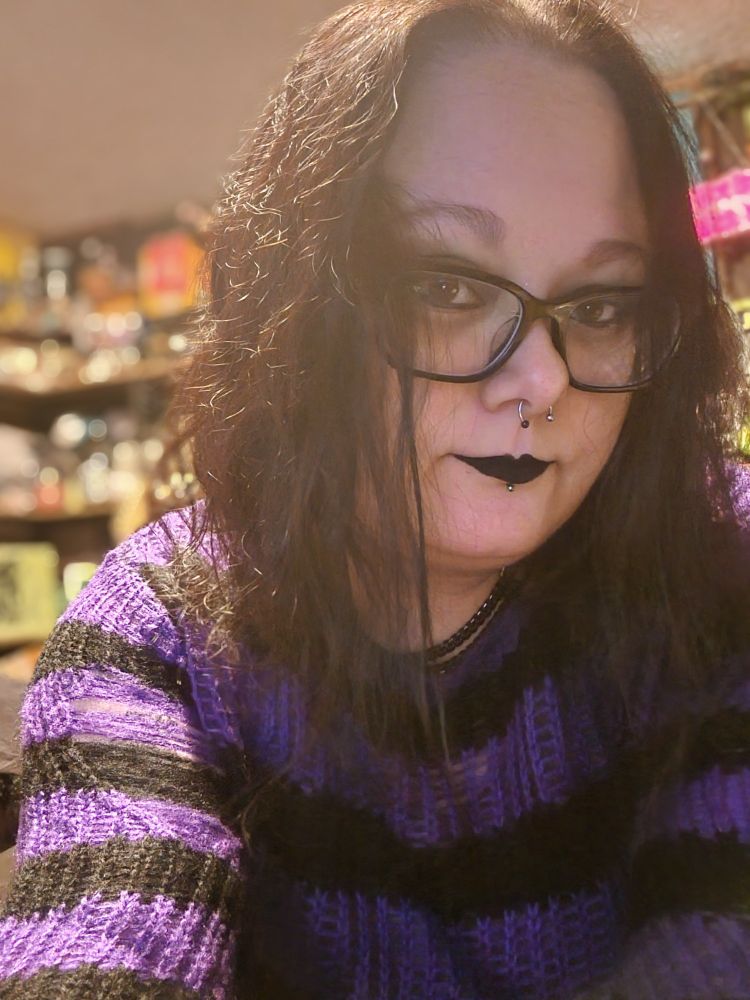 Photo of embervania wearing a purple sweater.