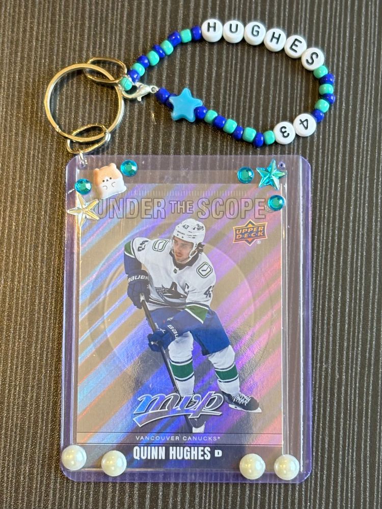 quinn hughes hockey card on a keychain 