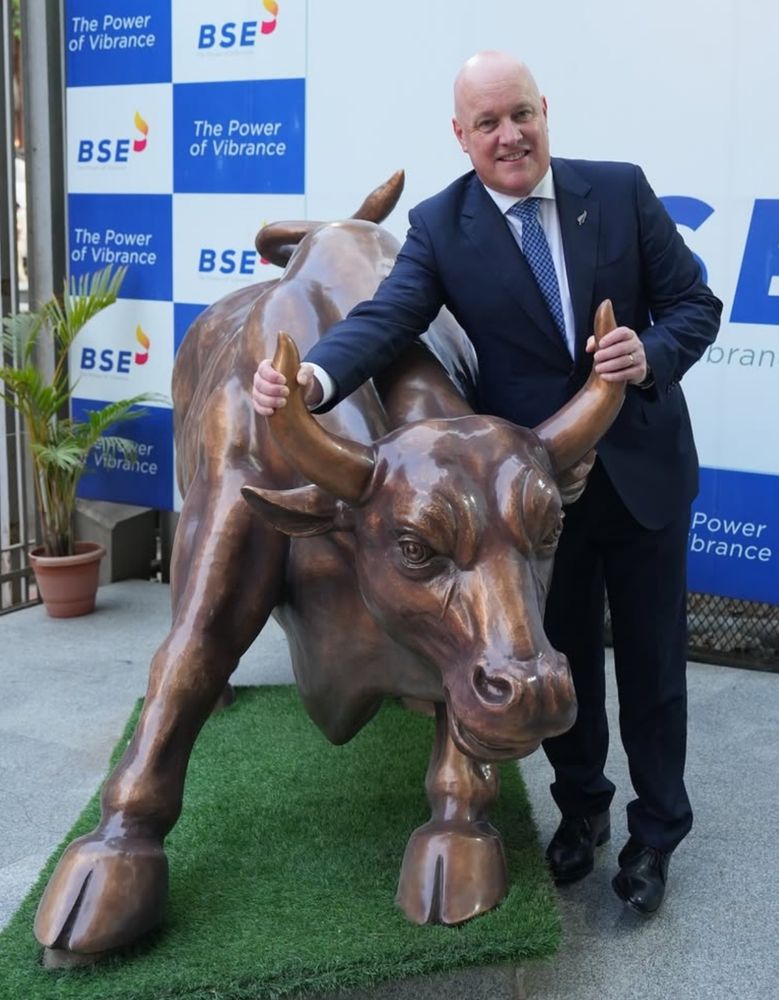 Luxon visits the stock exchange in Mumbai (now known as the BSE but he refers to it as the Bombay Stock Exchange) and decides he needs a photo of himself gripping the horns of the bull sculpture. 