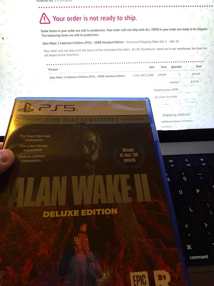 A computer screen showing a web page from Limited Run Games with the text “Your order is not ready to ship.” Referencing an order for Alan Wake 2. A physical PS5 copy of Alan Wake 2 is being held in the foreground, send from Limited Run Games.