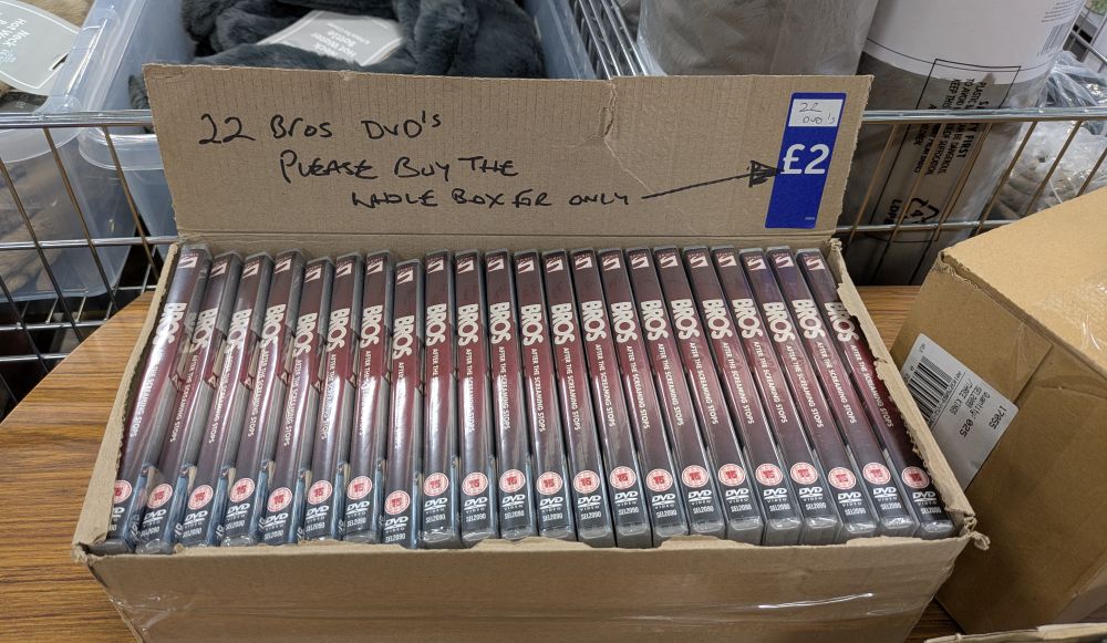 A box of 22 DVDs of the documentary "Bros, after the screaming stops".

On the box is "22 Bros DVD's. Please buy the whole box for only £2"
