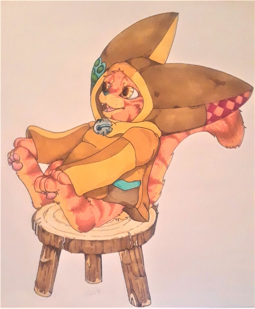 Orange kitten in a patch work leather hoodie sitting on a stool.