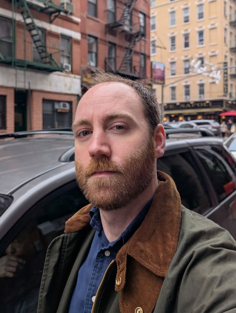 A man with a fresh cut poses for a selfie in Chinatown