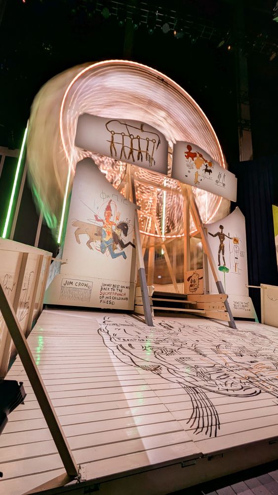 A ferris wheel designed by Jean-Michel Basquiat. The exterior of the ride is adorned with original Basquiat paintings