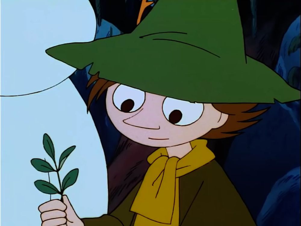 Snufkin is holding a little branch. 