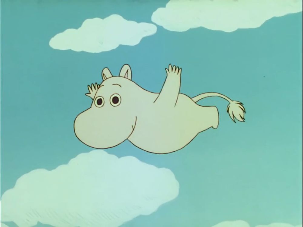 Moomin flying in the sky. The sky is blue with clouds.