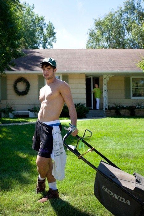 super hot cute dude shirtless, leaning on mower