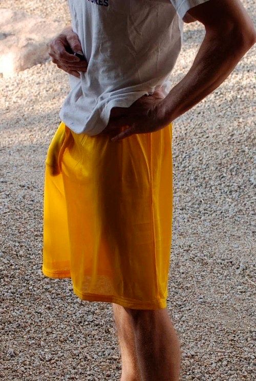 skinny dude outside wearing translucent loose shorts. light angle shows his dick hanging hot and heavy