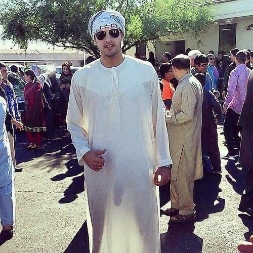 Dude wearing a thobe or sherwani in public with the light shining thru it showing his huge dick hanging there