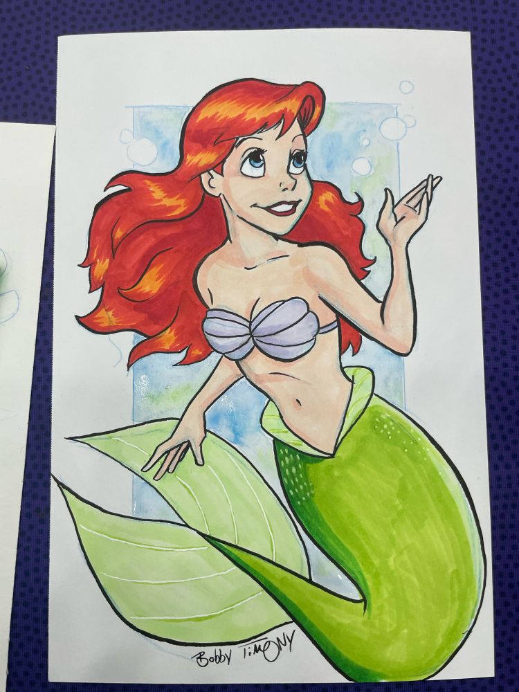 A drawing of the Little Mermaid by Bobby Timony. Drawn at Baltimore ComicCon, with pencil, ink, magic markers and watercolor.