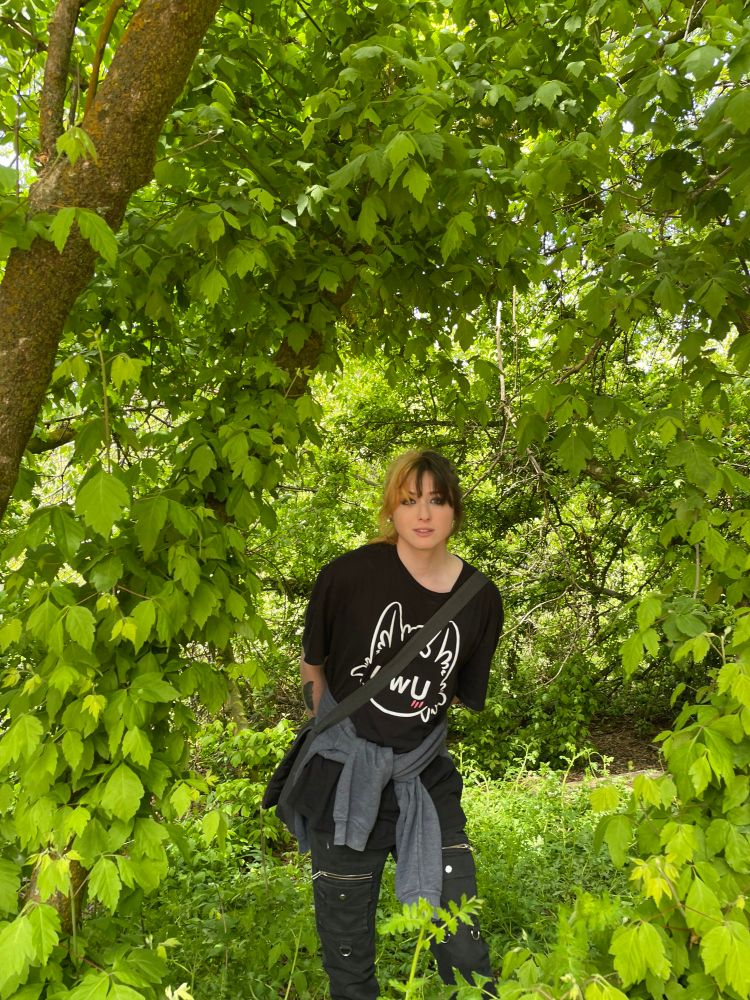 Zoey stands in nature wearing an UWU cat shirt. its black and white and it fits real good and no you cant have it. stop asking. 

oh shit almost forgot! Zoey has mostly dyed hair now. her friends have made blonde jokes a bunch and a few of them kind of landed. 