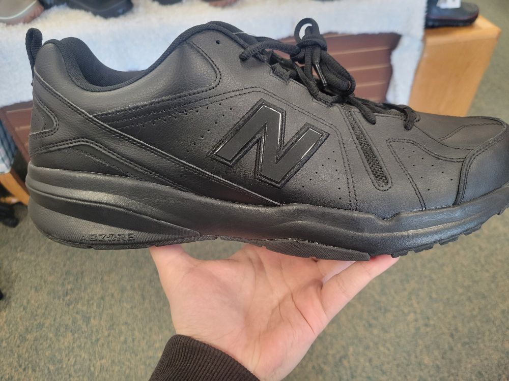 My hand holding a size 18 4E shoe.