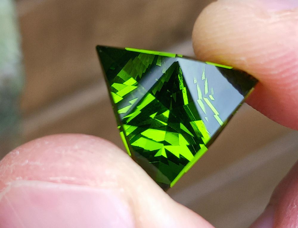 Sparkley green gemstone in a triangular cut