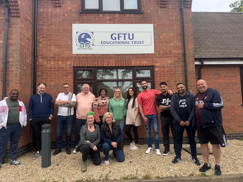Group of people standing in front of the GFTU Educational Trust building.