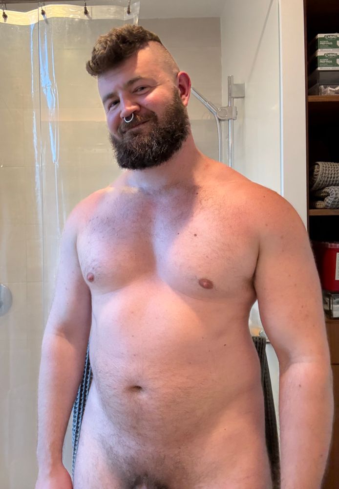 shirtless muscular man with a mohawk showing off his chest
