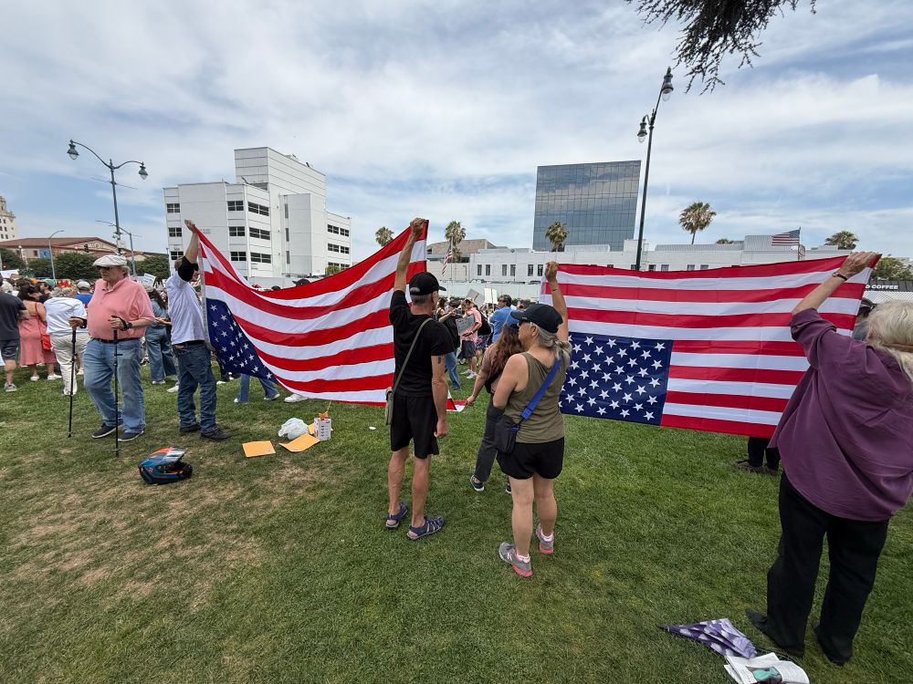 Two US flags held upside down 