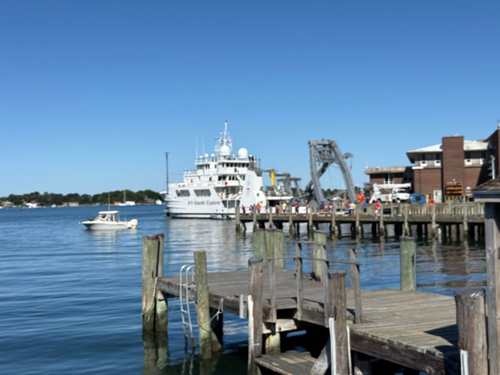 The R/V Atlantic Explorer in white at WHOI Smith dock with Woods Hole Great Harbor behind 
