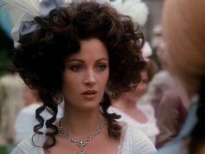 still photo of English actress Jane Seymour (white lady with her dark hair piled into a cloud of ringlets, in a white period dress) from the 1982 film The Scarlet Pimpernel, did you know Jane was fluent in Dutch and French as well as English? Amazing woman fr