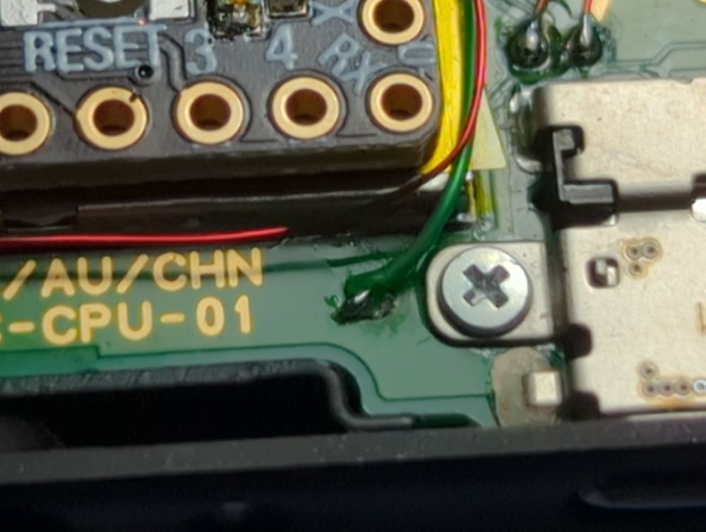 Wire soldered to ground point and wires soldered to USB data pads on Switch main PCB