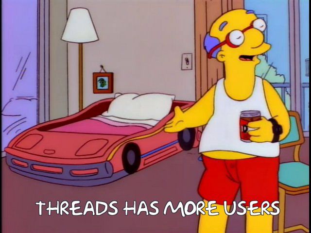 Milhouse's loser dad points to a race car bed for children and says "Threads has more users"