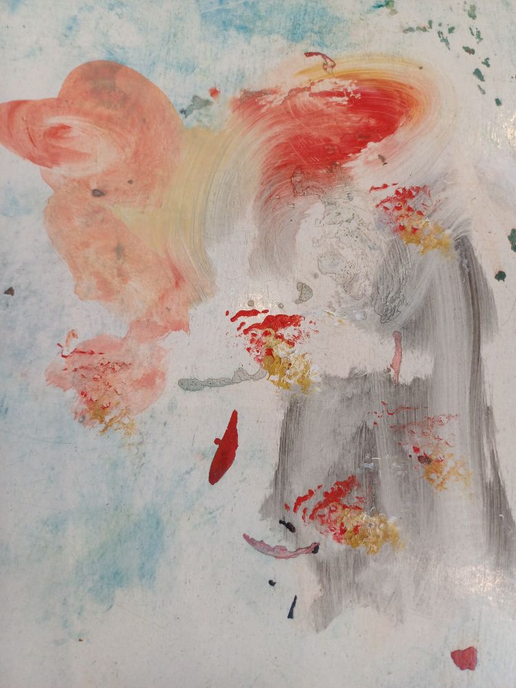 Verspielt verschmierte Farbpalette in rot, grau gelb und etwas ocker.