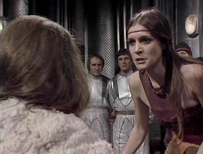 

Claude Sonnet 4.0 describes the image as: "This appears to be a scene set in what looks like a spaceship or futuristic facility, with metallic corridors and industrial lighting visible in the background. The scene shows several characters in period-appropriate costumes - some wearing light-colored, loose-fitting garments while others are in darker clothing. The setting has the distinctive production design typical of late 1970s science fiction television, with practical lighting effects and corridor sets. The characters appear to be engaged in dialogue, with the composition suggesting this is likely a dramatic or tense moment in the episode. The costumes and set design reflect the show's budget-conscious but creative approach to depicting a futuristic universe."

Blakes7Bot, version 3.9.31. AWS Lambda version: 1.14.