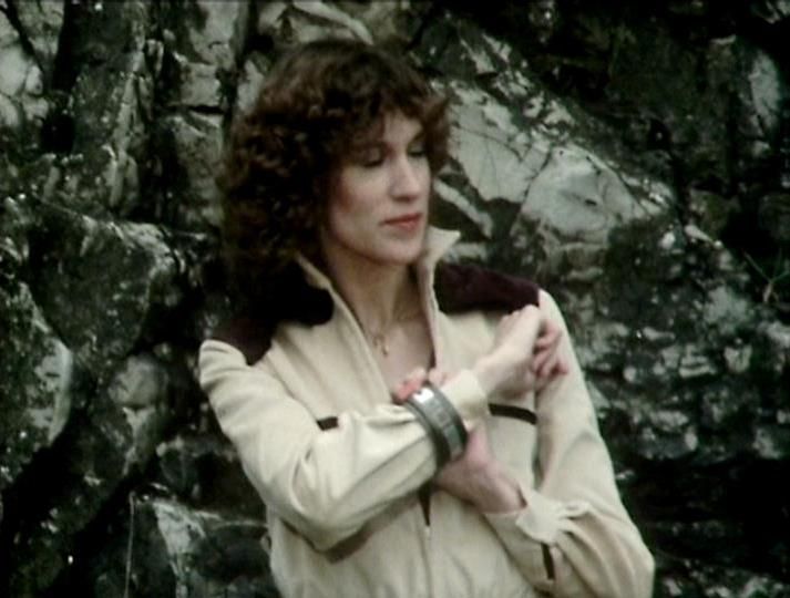 

Claude 3.7 describes the image as: "The image shows a person with curly dark hair wearing a cream-colored outfit with dark accents against a rocky backdrop. The clothing style and the film quality suggest this is from a classic science fiction television production, likely from the late 1970s or early 1980s based on the aesthetic. 

The setting appears to be an outdoor location with stone or rock formations creating a somewhat stark, possibly alien landscape. The costume has a distinctive design with contrasting elements and what looks like a bracelet or cuff visible on the wrist.

The somewhat muted color palette and filming style is characteristic of British television productions from that era, with the natural setting possibly serving as an alien planet or remote location in the storyline."

Blakes7Bot, version 3.9.31. AWS Lambda version: 1.14.